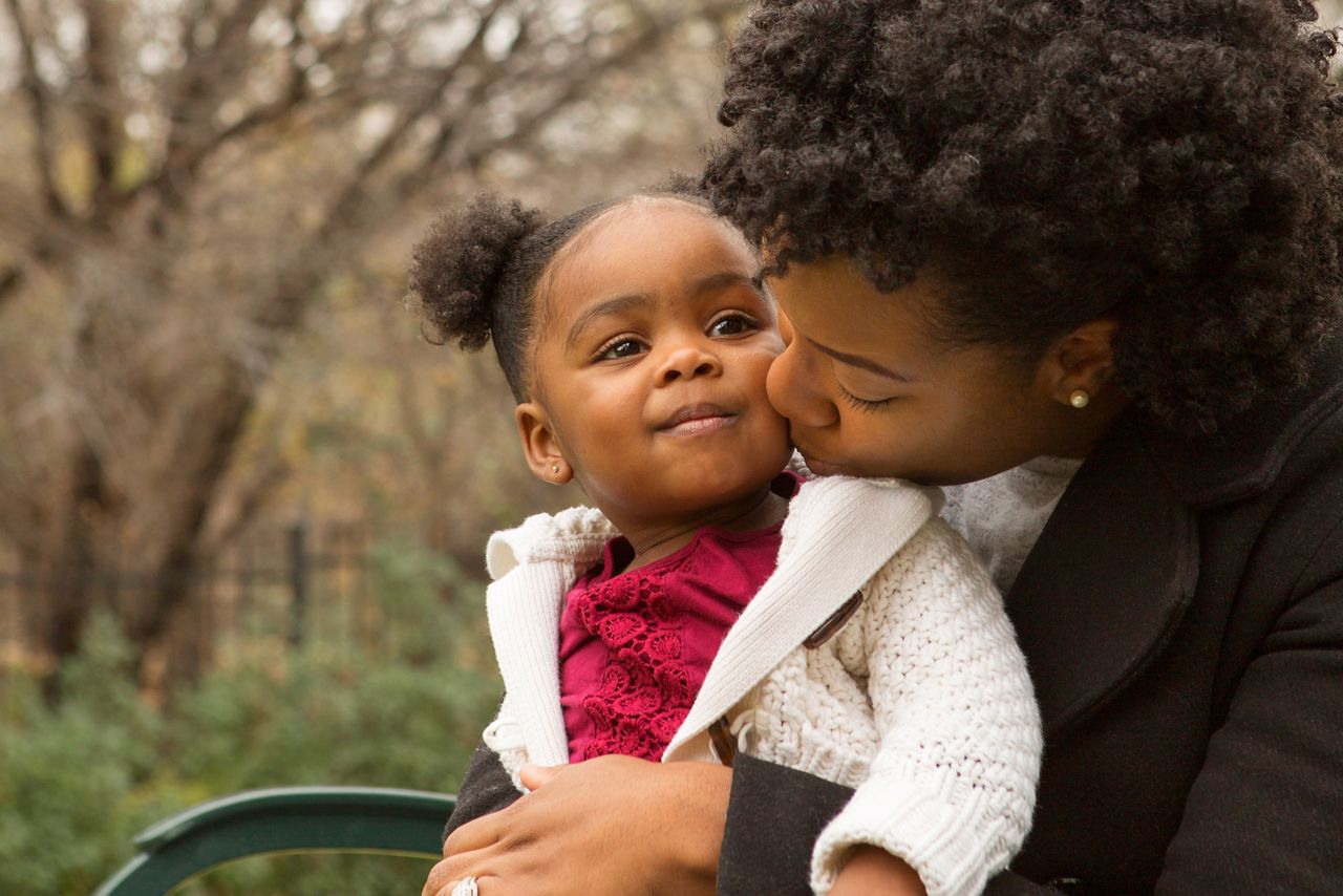 Happy African American mother and her daughter.