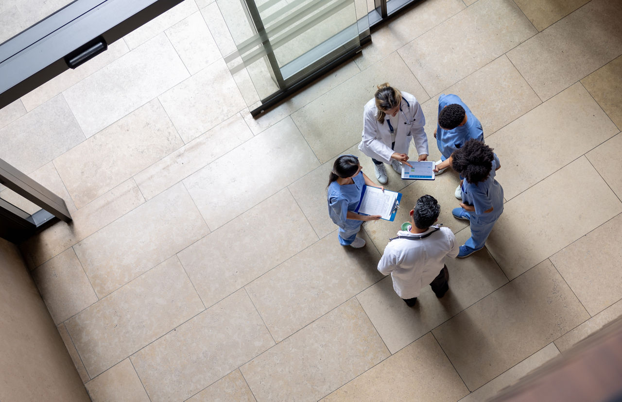 High angle view of a group of doctors looking at some test results in a meeting at the hospital