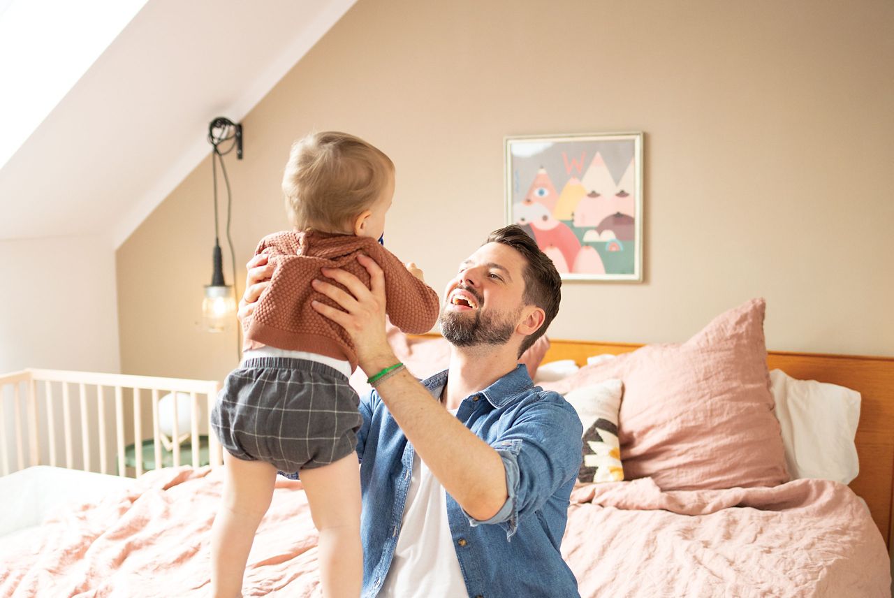 Vater hält Kleinkind in die Luft