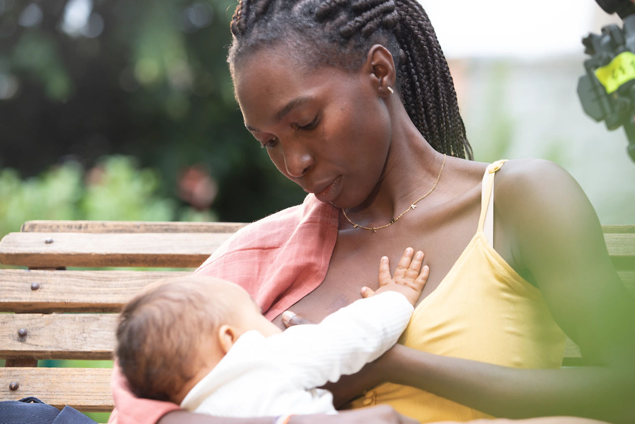 Mother breastfeeding on a bench