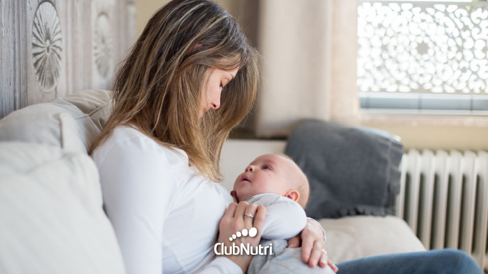 Breastfeeding baby on bed