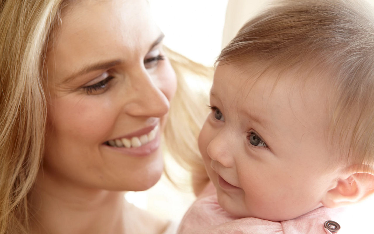 mother and baby smiling