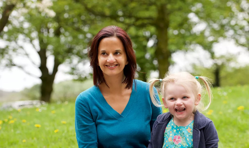 Mother and daughter sitting on a bench