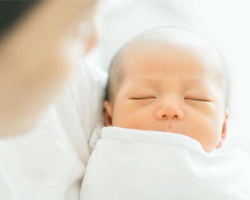 mother-holding-baby-top-baby-names-small.png