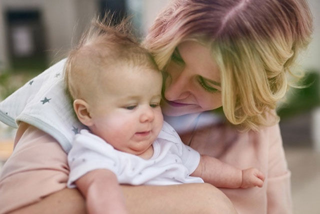 mother holding newborn