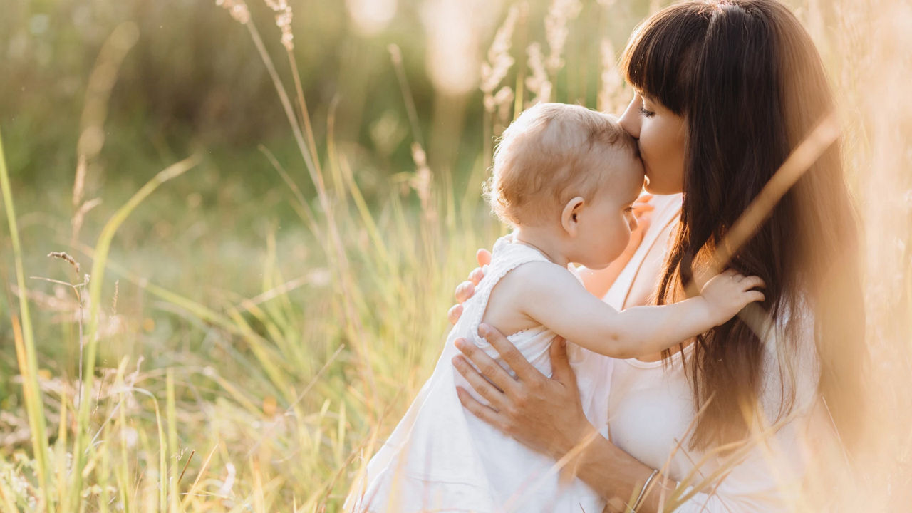 Mother kissing baby