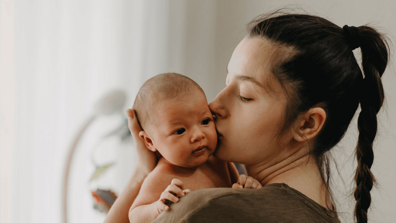 mother-kissing-baby-on-cheek