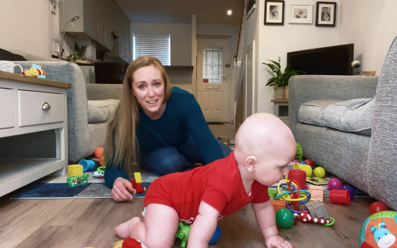 pregnanct couple with baby shoes 