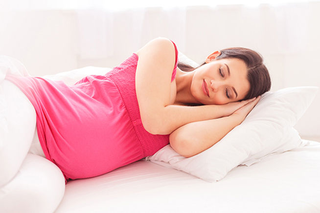mujer embarazada con top rojo durmiendo