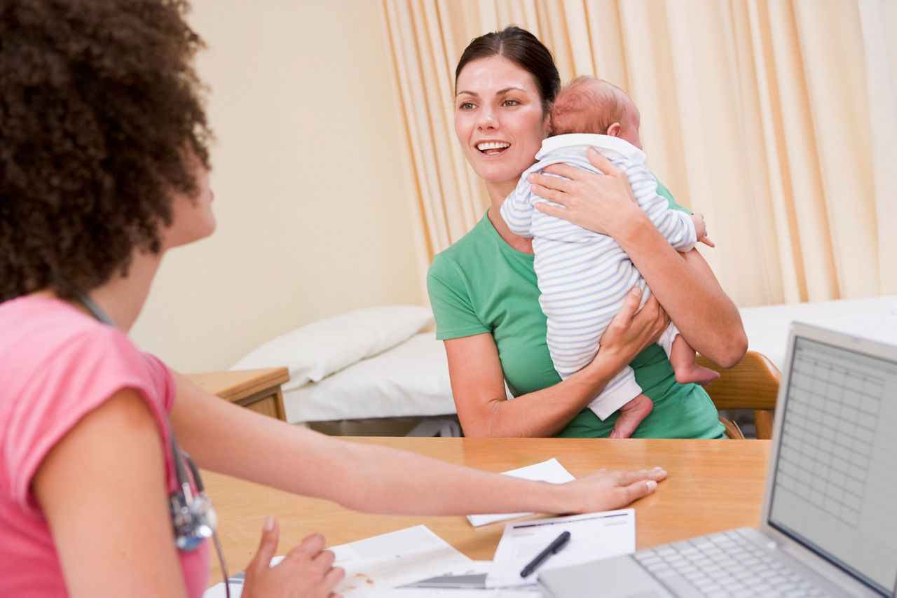 Mother holding a baby with allergy on his back