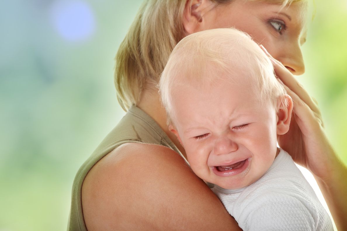 Mother holding her crying baby; Shutterstock ID 53218480,mum holding her crying baby