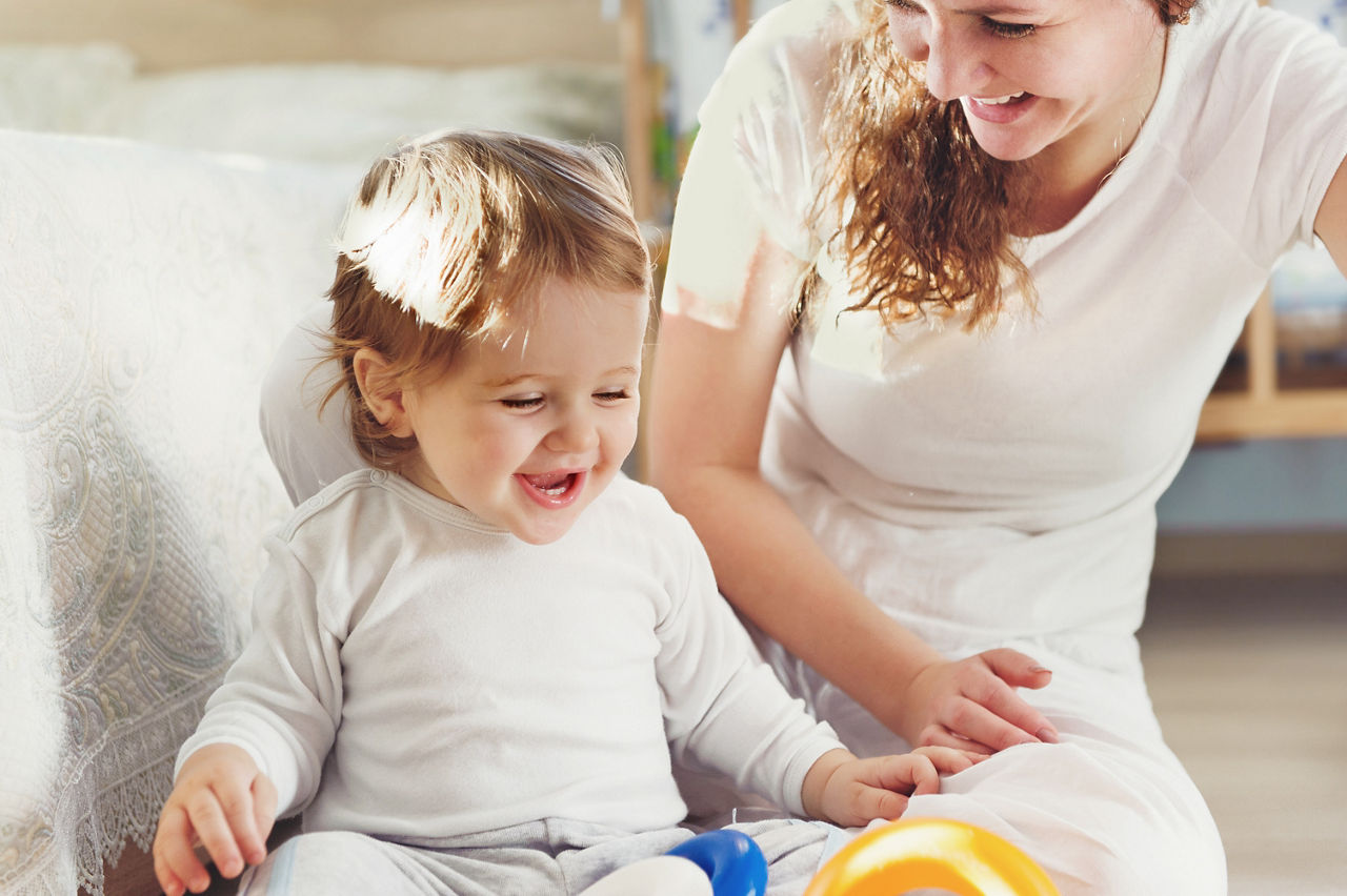 Young mother playing with her baby son at home; Shutterstock ID 154481066,mum playing with baby son