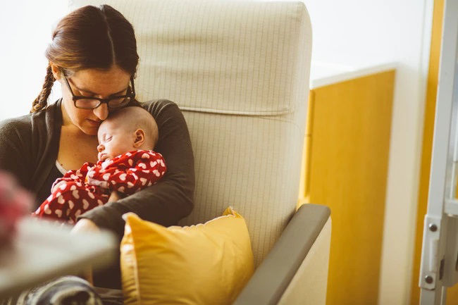 Mum sitting baby asleep