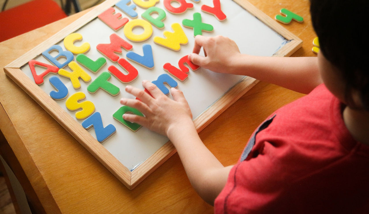 kid is Learning the alphabets at home.