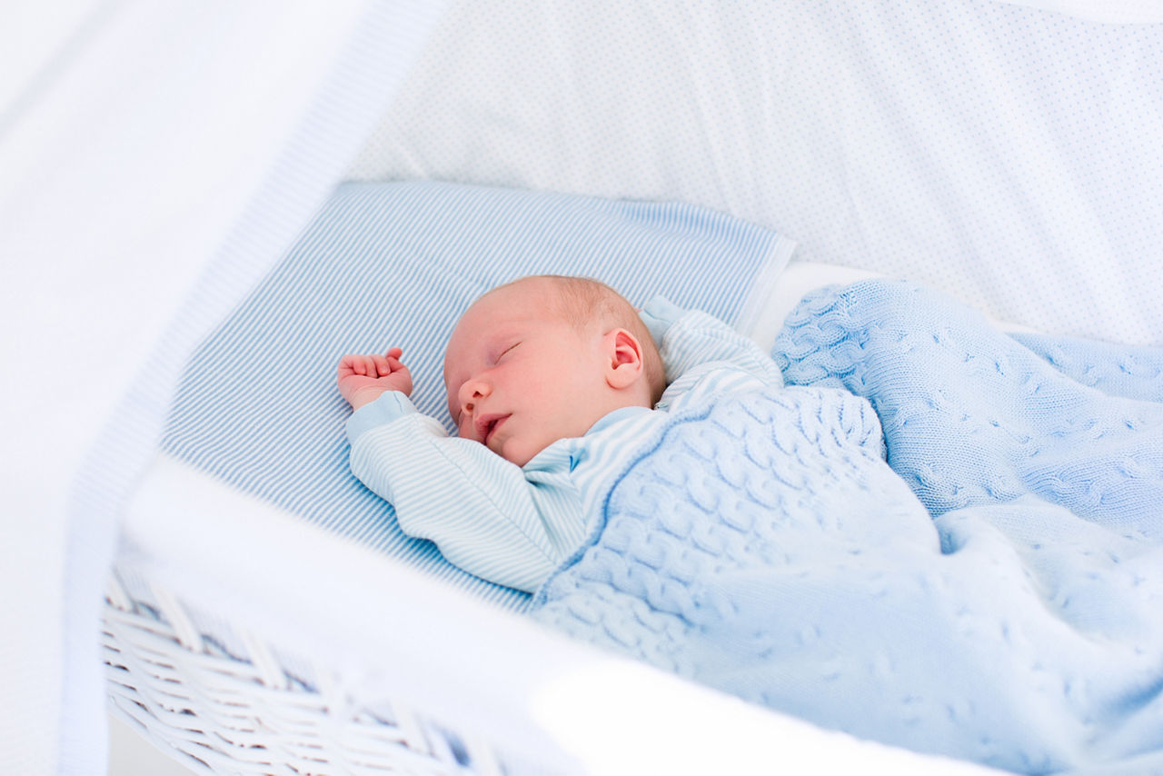 Newborn baby boy in bed. New born child sleeping under a blue knitted blanket. Children sleep. Bedding for kids. Infant napping in bed. Healthy little kid shortly after birth. Cable knit textile.; Shutterstock ID 300995090,newborn baby in blue bed