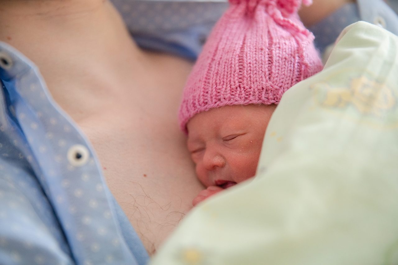 mom-bottle-feeding-baby-bed