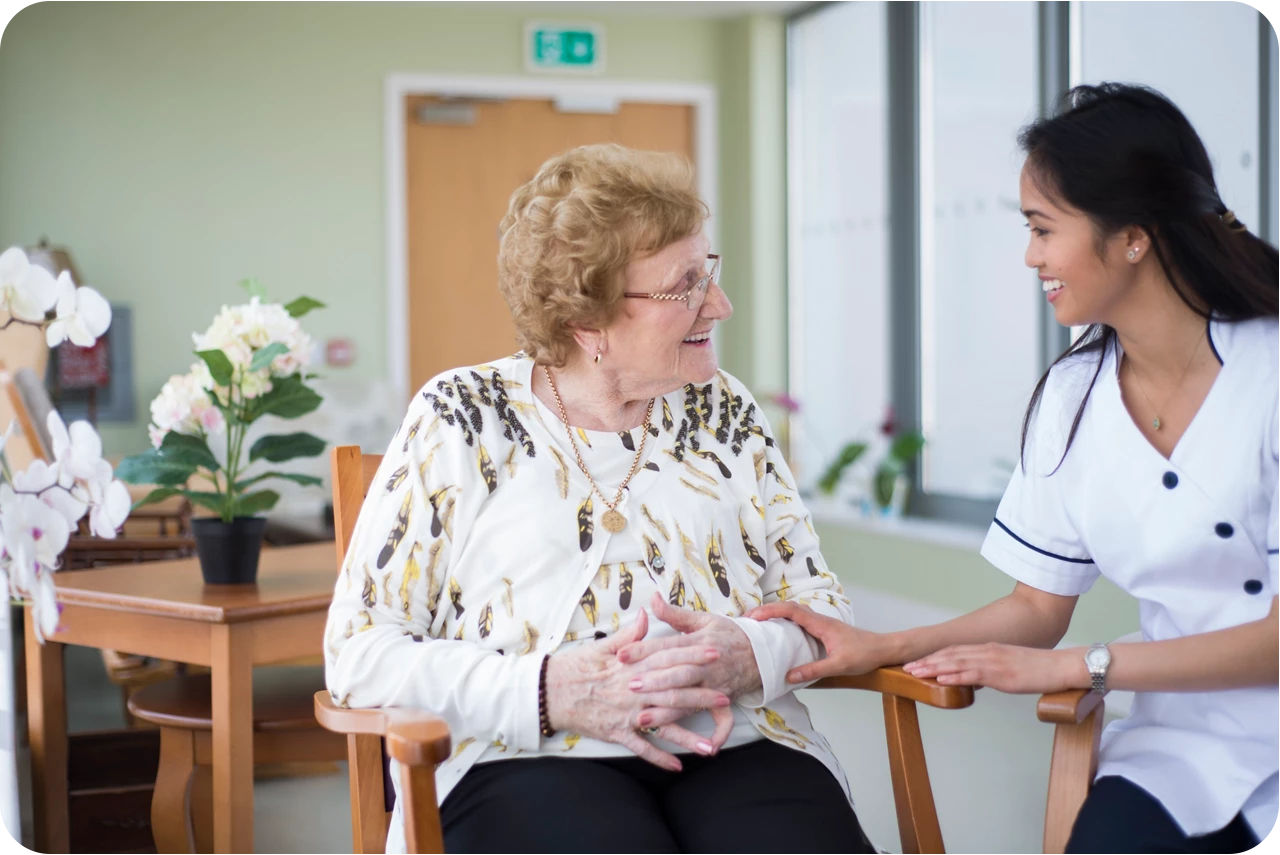 Elderly woman speaking with a nurse