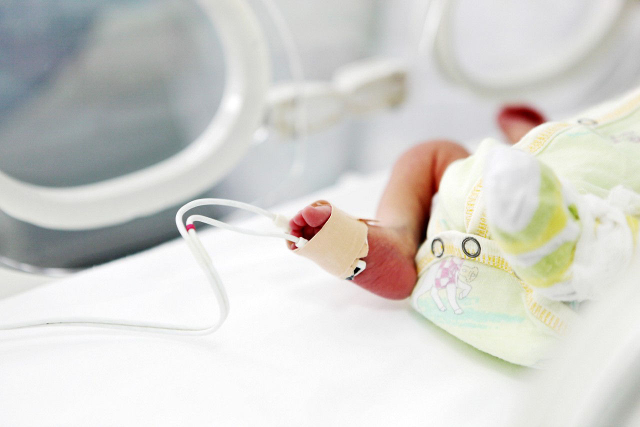 Close-up of a pre-term baby foot with a foot monitor attached