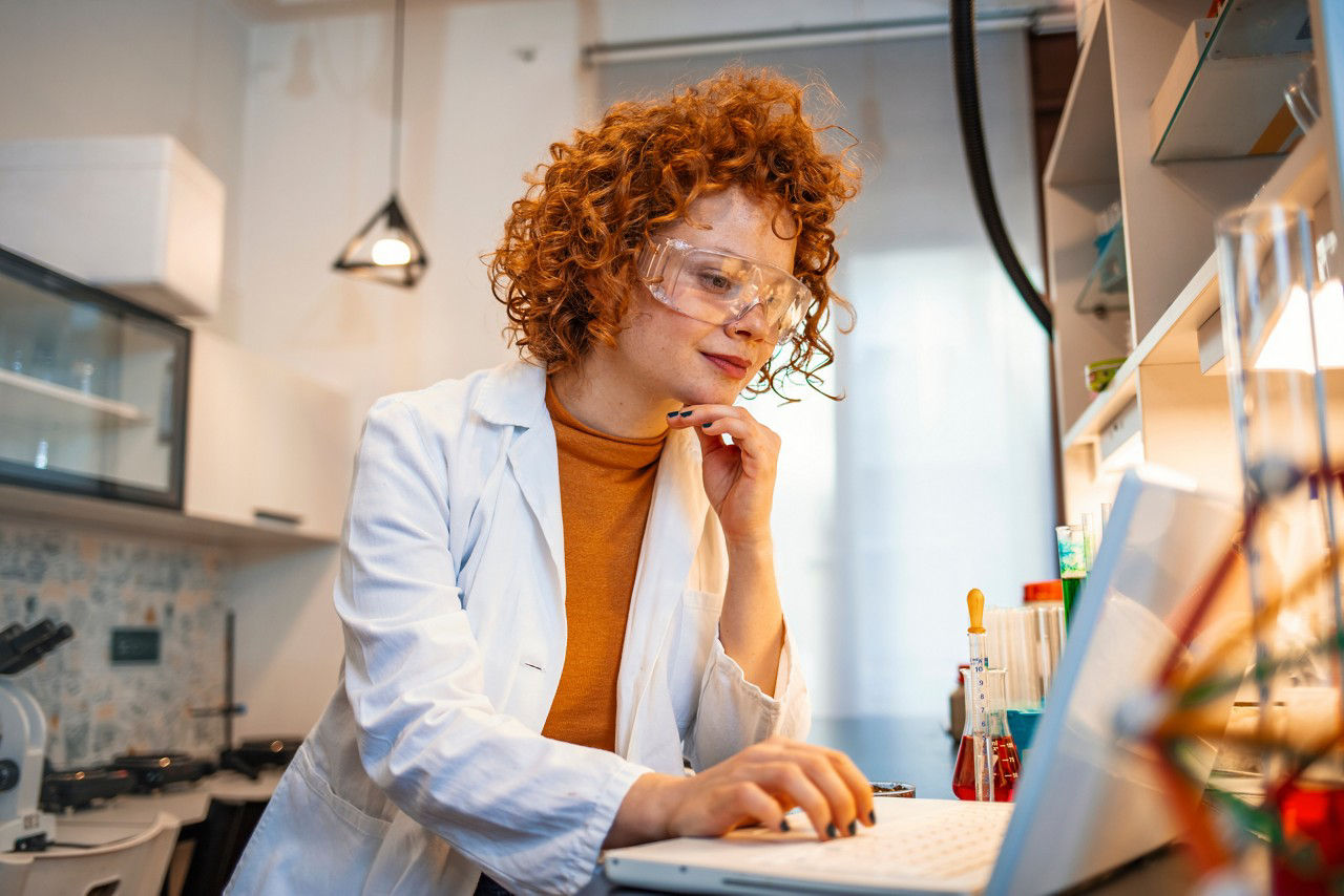 Doctor in an office researching on her laptop