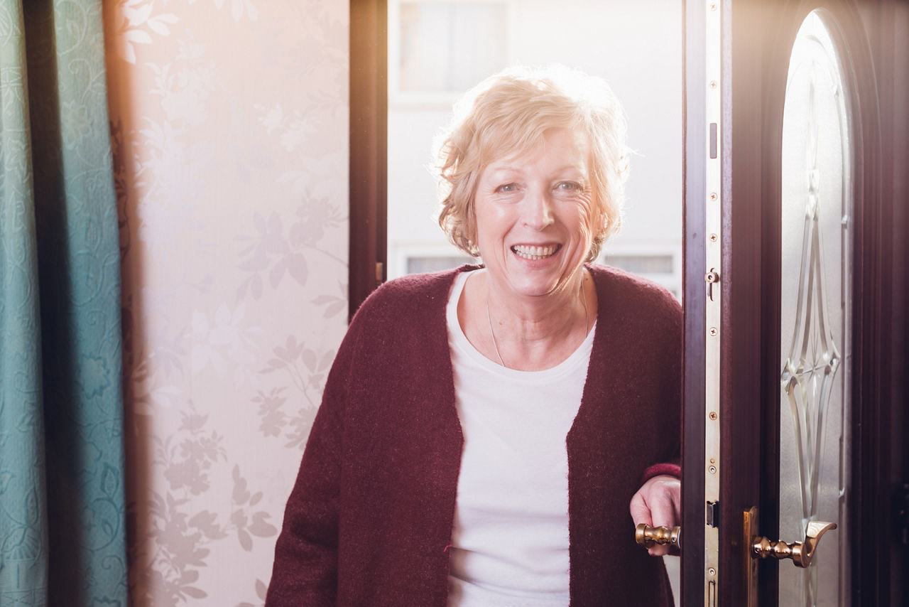 Elderly person entering house