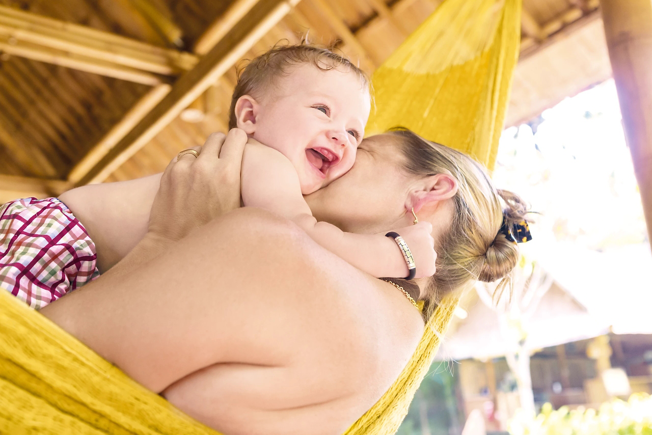 mum kissing baby girl