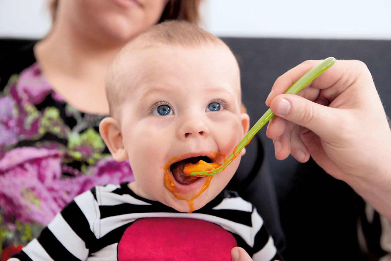 Baby being fed with a spoon