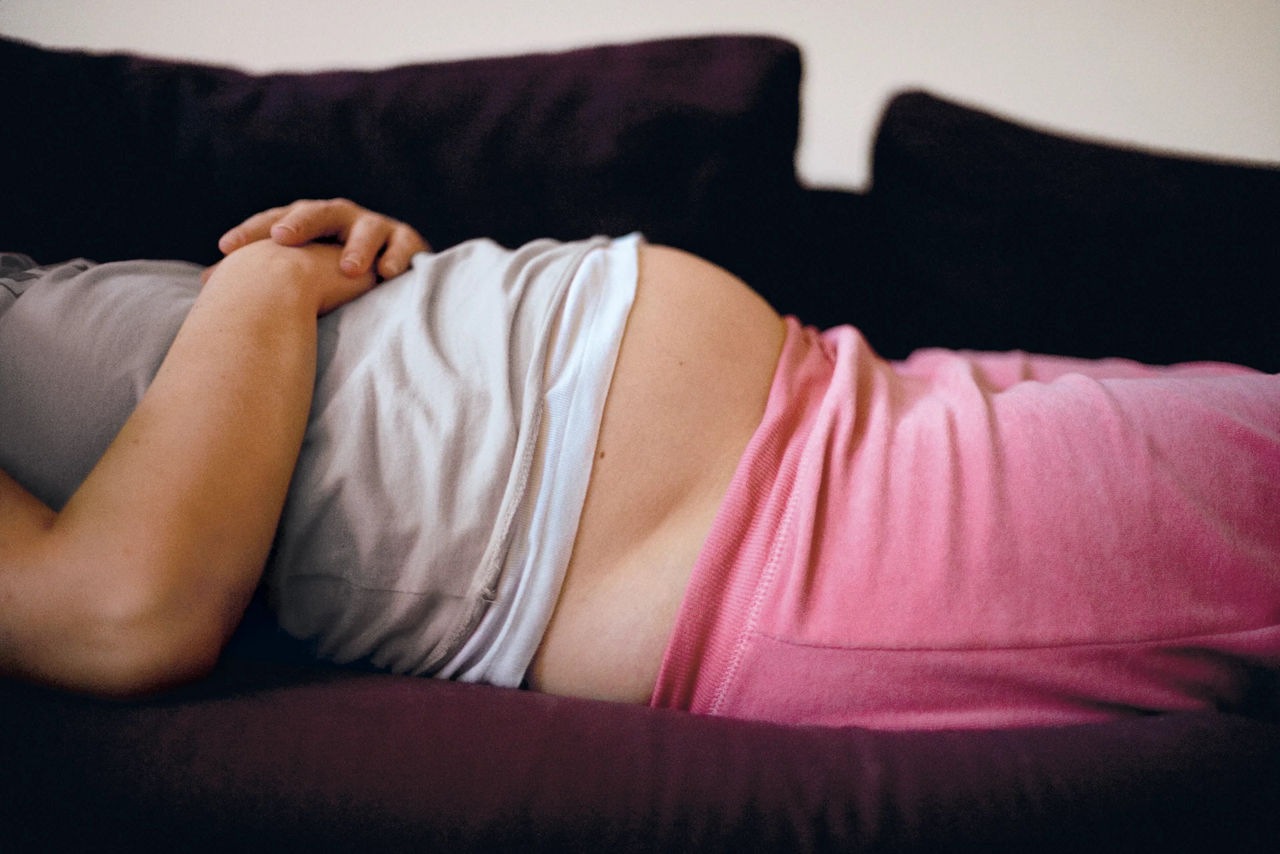 pregnant laying down on the sofa