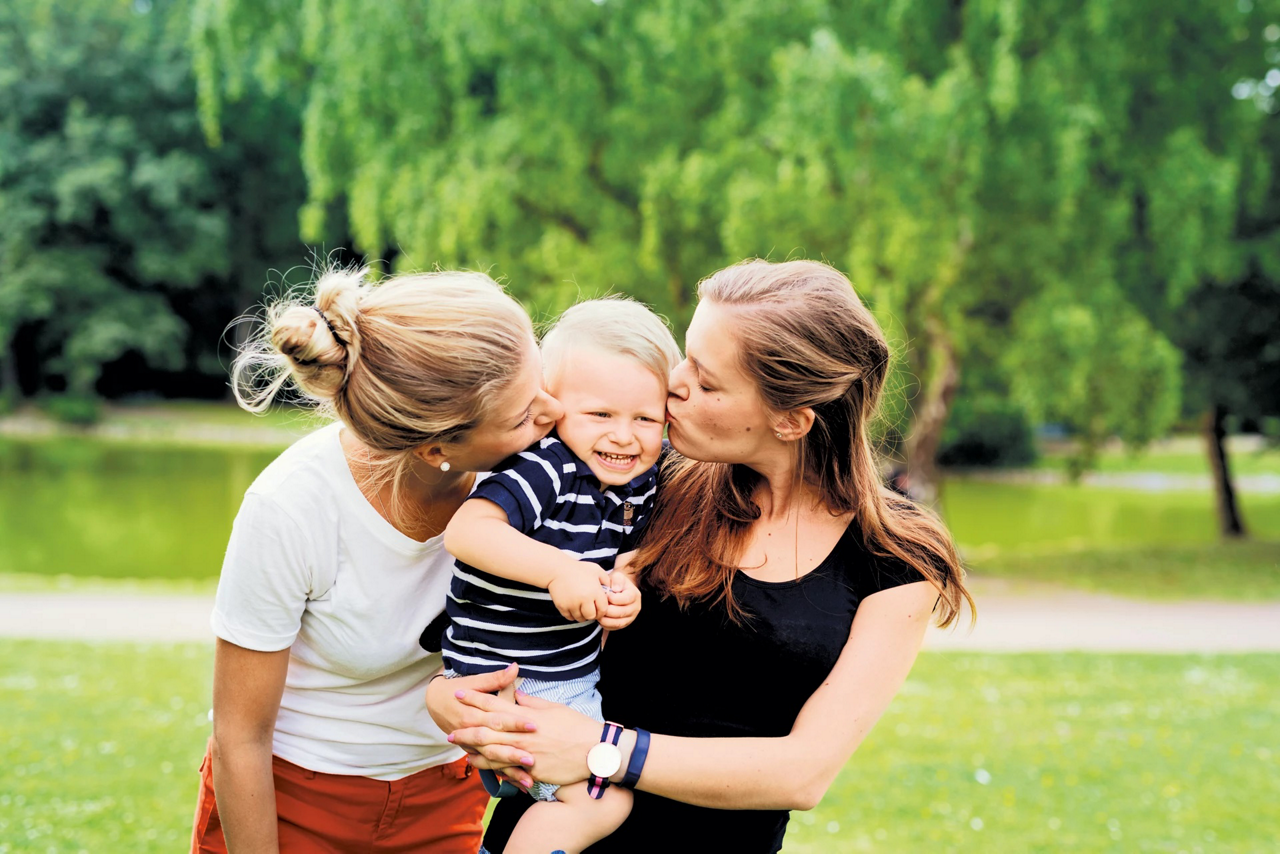 toddler kissed by 2 women