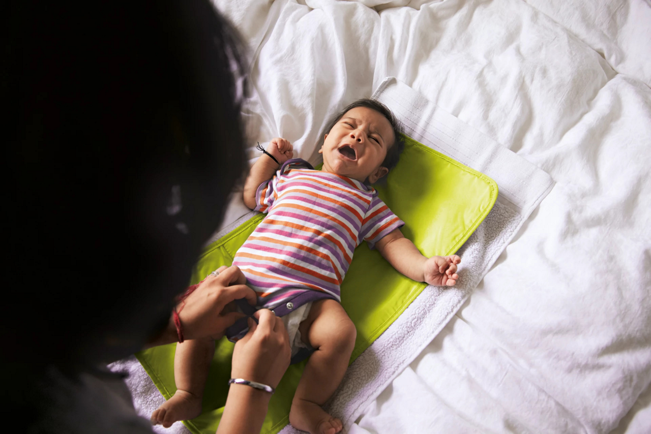 baby craing on bed