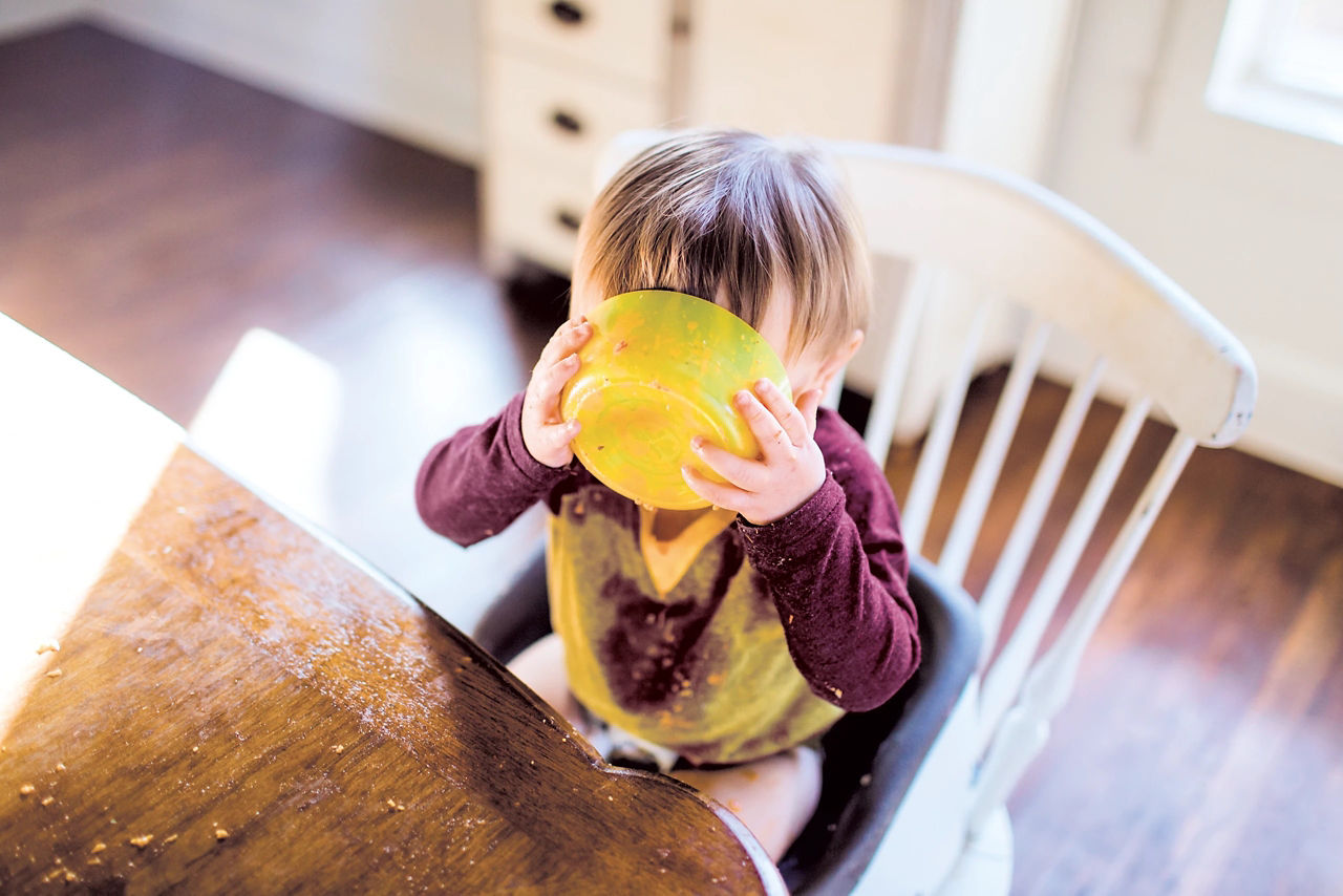 Toddler eating with fork