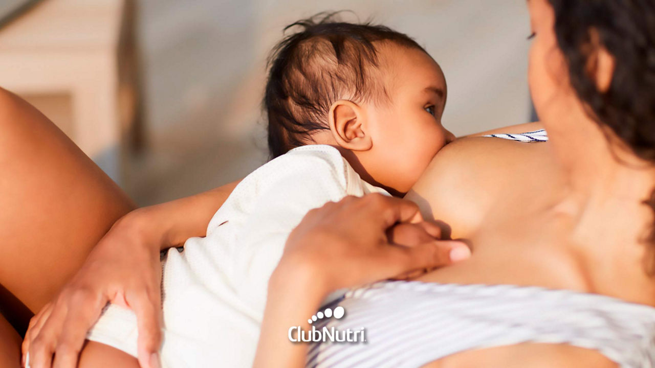 Breastfeeding baby on bed