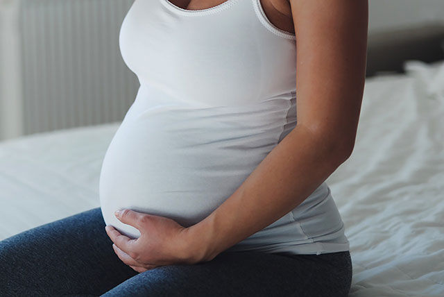 pregnancy mum holding bump white
