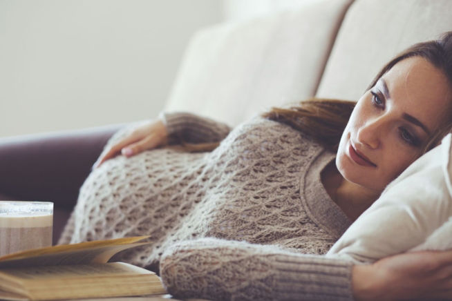 pregnant woman lying on couch