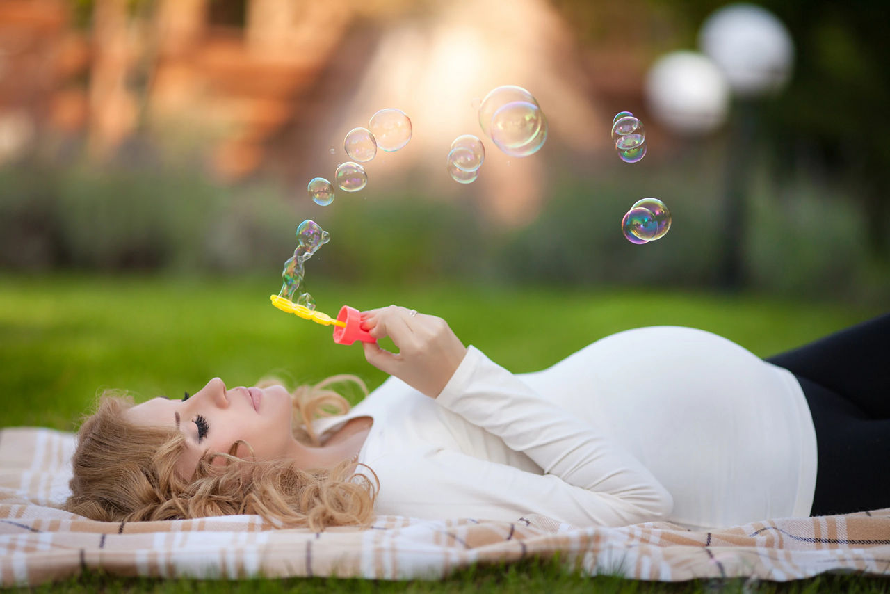 Pregnant woman relaxing park