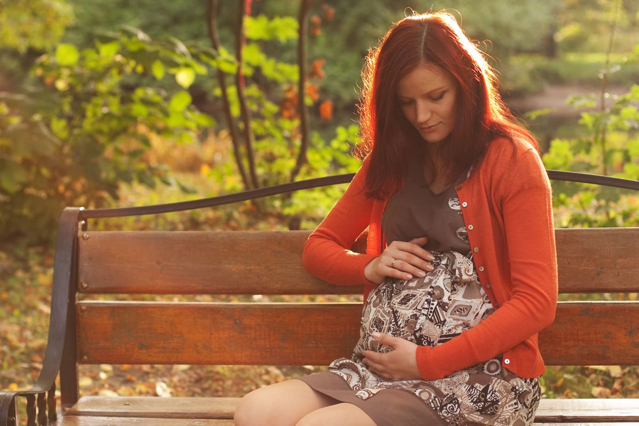 Pregnant woman walking autumn