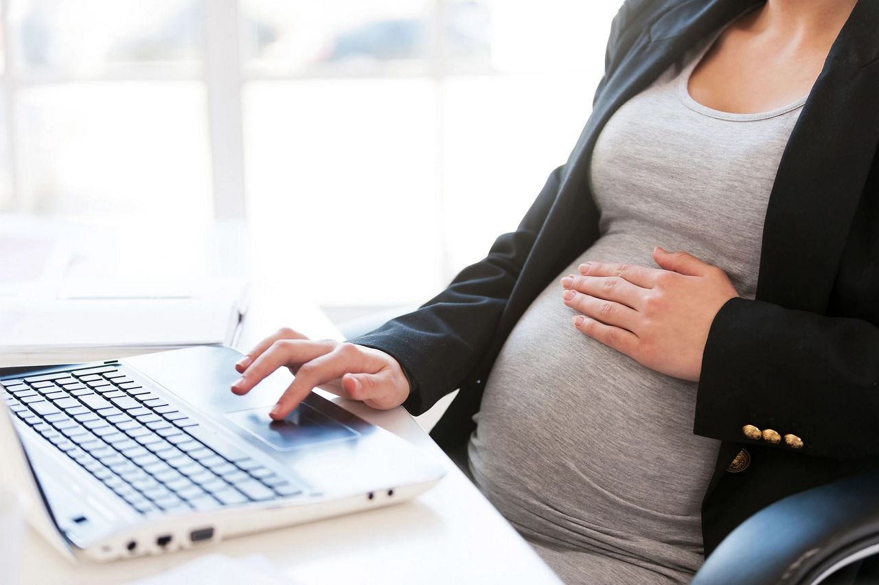 Pregnant woman working laptop