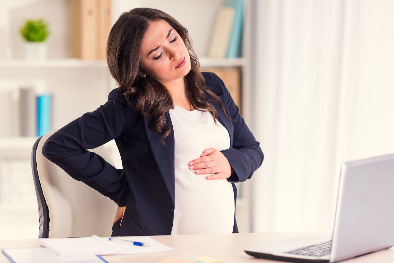 Disease back. A young pregnant woman holds back, while working in the office; Shutterstock ID 357685370,pregnant woman in work with a sore back