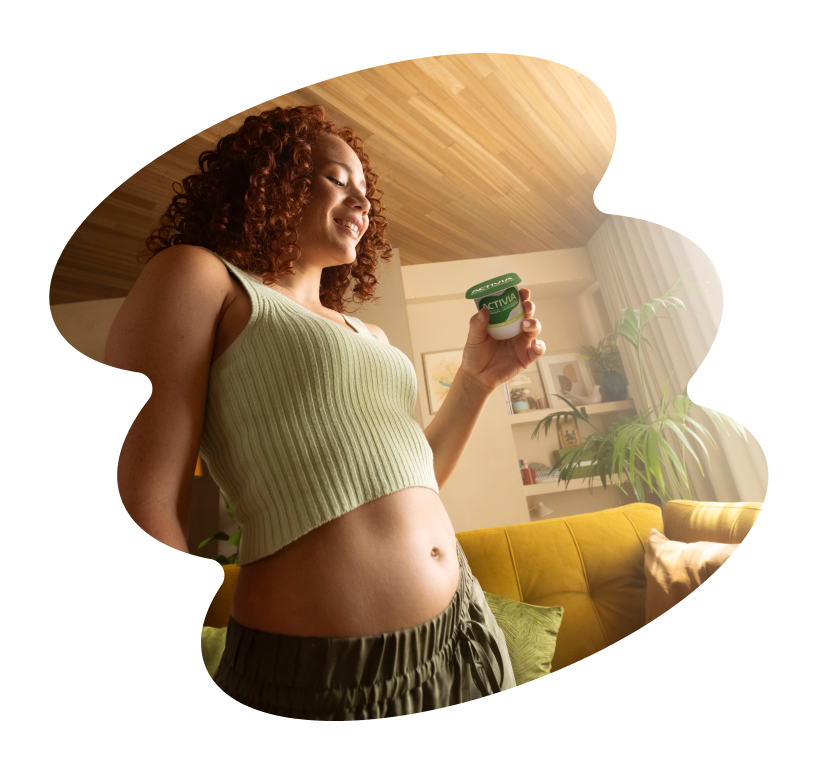 Smiling woman holding Activia yogurt