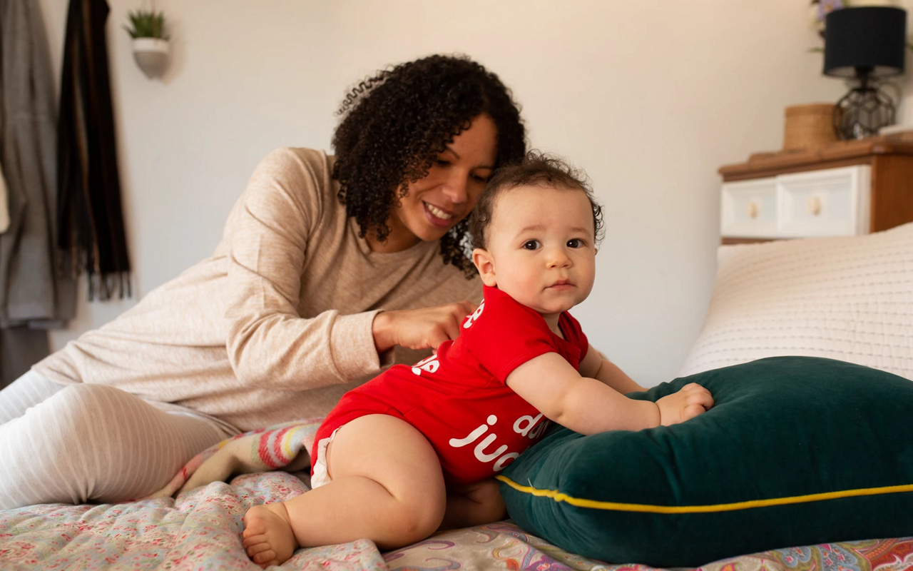 mother with baby on bed