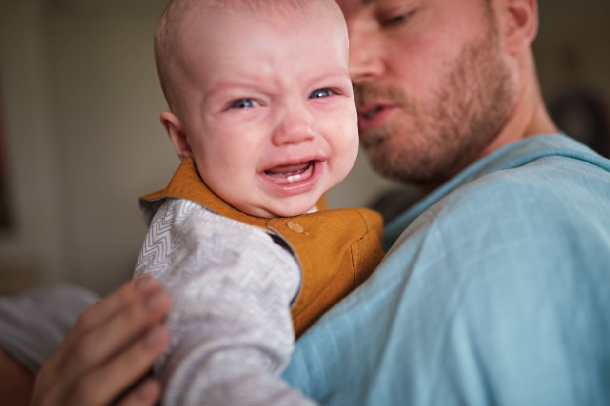 Mother holding baby's finger while is a hospital