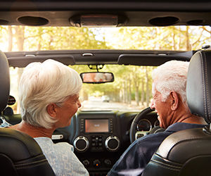 Senior couple driving in a car