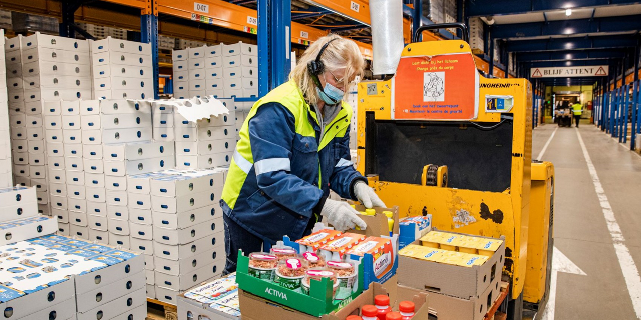 Rotselaar worker unpacking yoghurt boxes