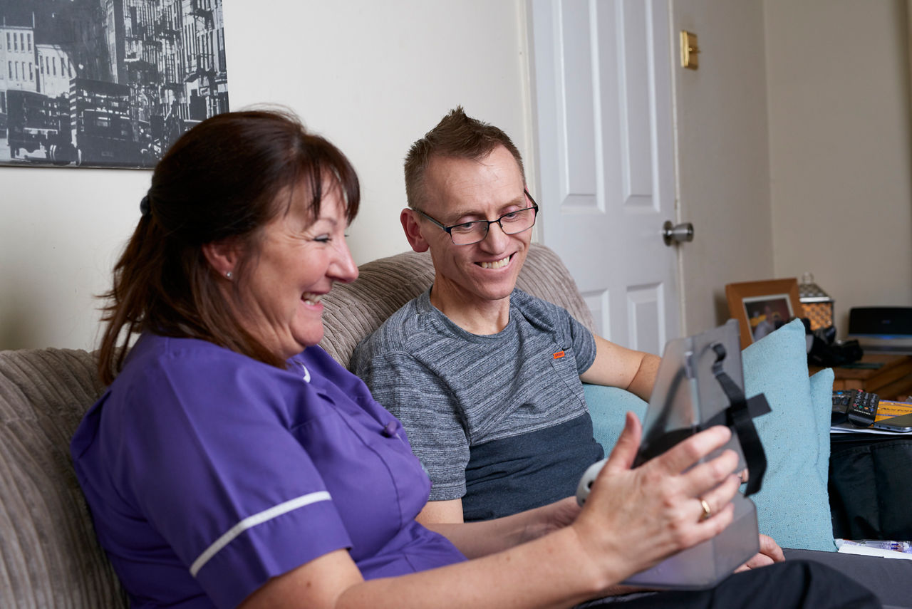 A Nutricia Homeward nurse laughing with a patient