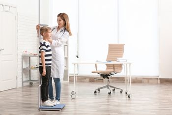 Doctor measuring little boy's height in hospital; Shutterstock ID 1117295222; purchase_order: DNC Thumbnails; job: Infographics; client: ; other: 