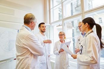 Doctors during medical training working together; Shutterstock ID 1138421711; purchase_order: DNC Thumbnails; job: Webinars 1 (50/189); client: ; other: 