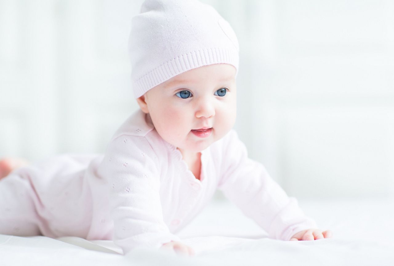 Happy smiling baby girl in a pink knitted hat; Shutterstock ID 115357645; purchase_order: DNC thumbnails; job: N&G videos; client: ; other: 
