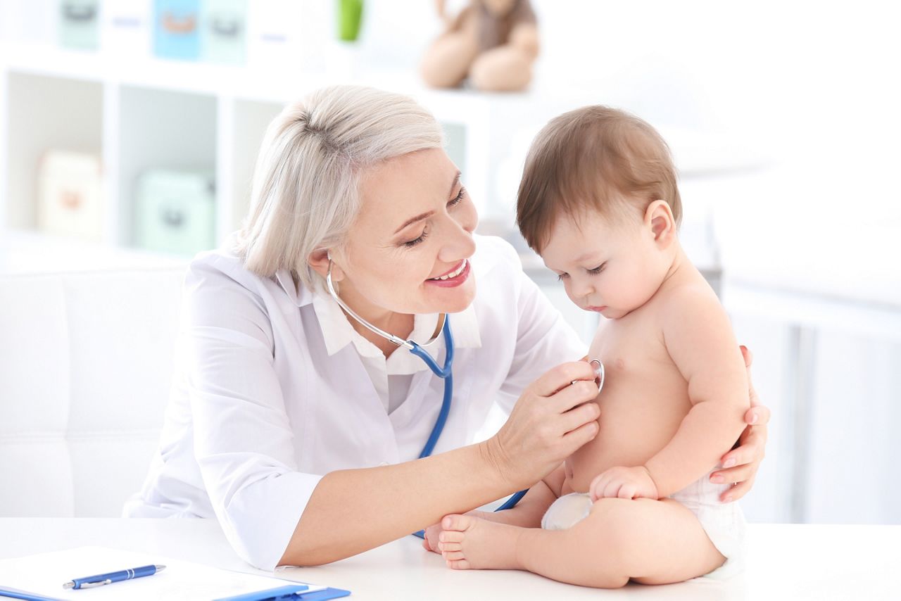 Mature female doctor examining baby boy in clinic; Shutterstock ID 1163987557; purchase_order: DNC thumbnails; job: ; client: ; other: 