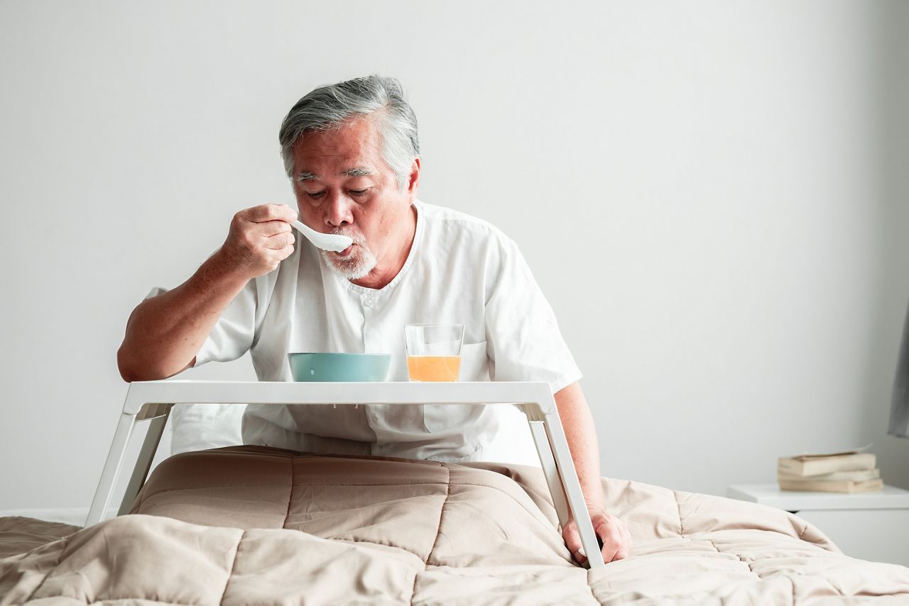 Senior man in bed enjoying breakfast. Old asian male with white beard eating congee and orange juice. Senior home service concept.; Shutterstock ID 1194876079; purchase_order: DNC Thumbnails; job: Webinars 2 (50/188); client: ; other: 