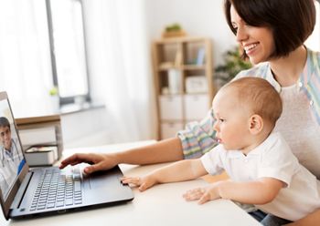 medicine, technology and healthcare concept - happy mother with baby son having video chat with family doctor on laptop computer at home; Shutterstock ID 1216210750; purchase_order: DNC Thumbnails; job: Webinars 3 (50/188); client: ; other: 