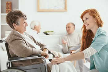 Redhead smiling nurse helping senior patient in hospice; Shutterstock ID 1217165413; purchase_order: DNC Thumbnails; job: Publications; client: ; other: Replace Fishwife